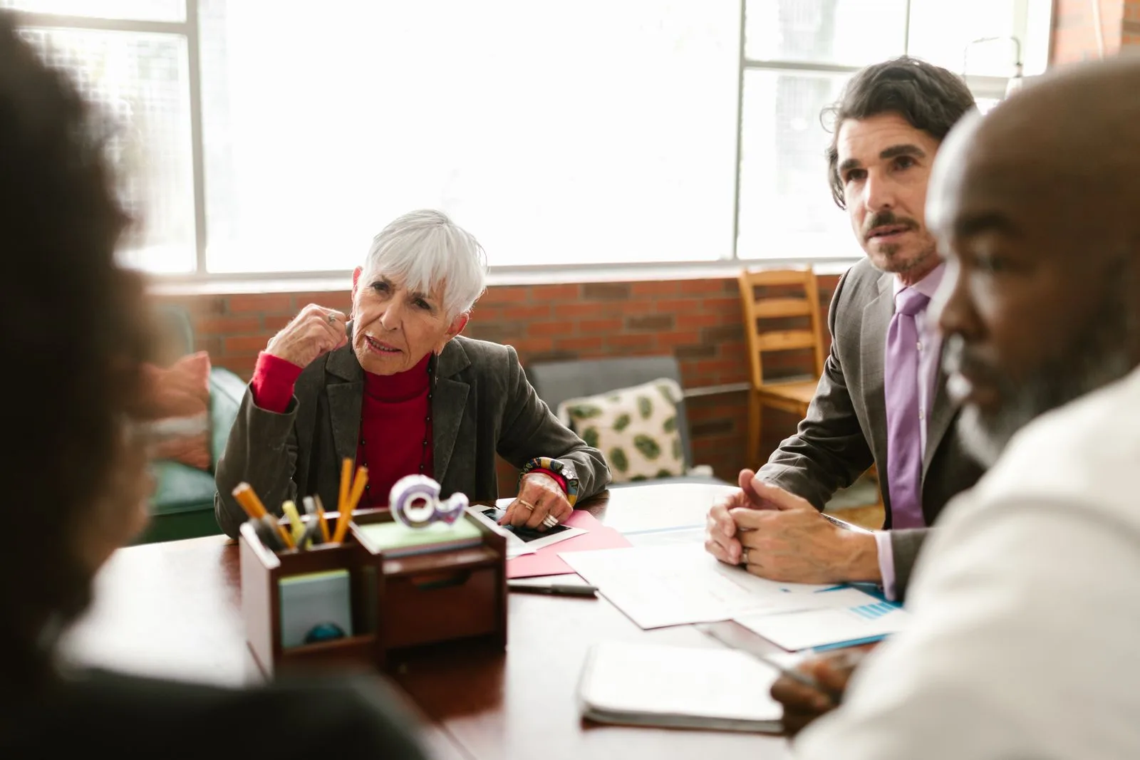 Professionals listening to one another during a meeting.